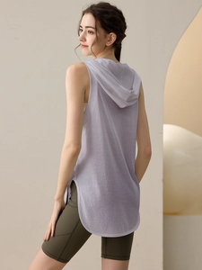 Women's loose lavender hooded fitness vest with high-waisted dark green biker shorts