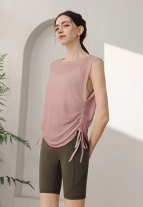 Detail of drawstring side on loose pink yoga vest with breathable mesh fabric texture