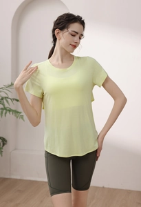 Short sleeve modal yoga top with open back and green high-waisted fitness shorts