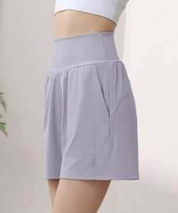 Detail view of high waisted lavender yoga shorts with side pockets and compression waistband