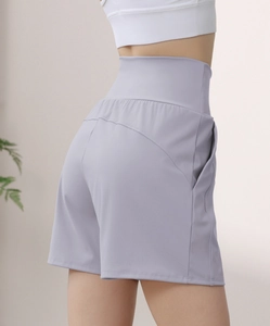 Detail view of high waist lavender yoga shorts featuring heart-shaped back stitching and side pockets
