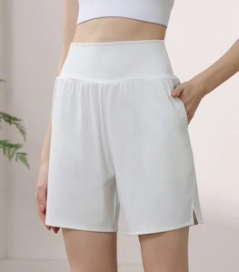 Detail of white high-waisted gym shorts with functional side pockets and quick-dry fabric