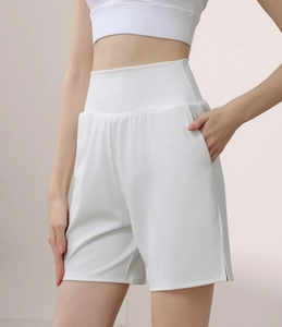 White high-waisted nylon sports shorts with side pockets and split hems for fitness