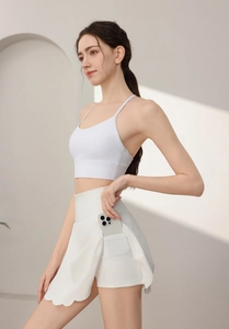Detail showing the practical side pocket of a white high-waisted petal tennis skirt