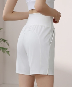 Detail view of white high-waisted gym shorts with side pocket and seamless booty lifting