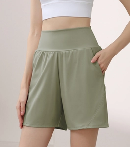Detail view of high waisted fitness shorts showing wide waistband and side pockets