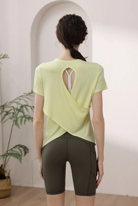 Detail of cross open back modal sports top and olive green high waist cycling shorts