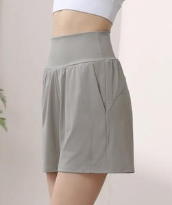 Detail view of high waisted dark gray yoga shorts with side pocket for phone storage