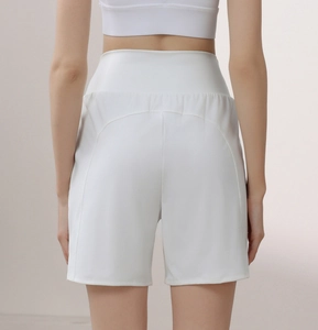Macro detail of high-waist white athletic shorts with lifting seam for yoga and running