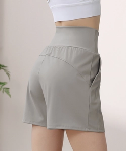 Detail of high waisted grey-green yoga shorts with supportive tummy control design