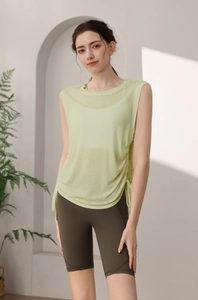 Detail of light green quick-dry yoga vest with side drawstring and high-waist biker shorts