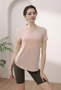 Short sleeve modal yoga top with open back paired with green high waist cycling shorts