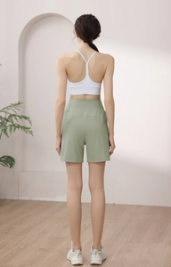 Rear view of high-waist light green loose athletic shorts with wide-leg design