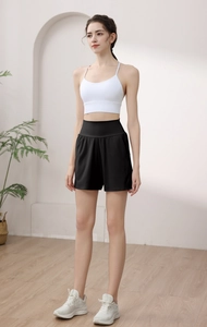 Detailed view of high-waisted black yoga shorts featuring wide compression waistband design