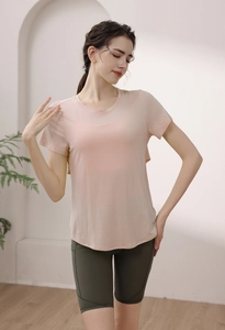 Detail of peach pink modal yoga top and dark green cycling shorts for fitness training