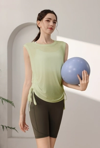 Detail of light green mesh yoga vest with adjustable drawstring and quick-dry fabric texture