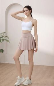 Detail of scalloped hem on high-waisted dry rose yoga skirt with moisture-wicking fabric
