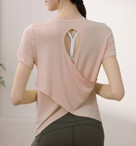 Detail of cross-back cutout on pink modal yoga top showing breathable fabric texture