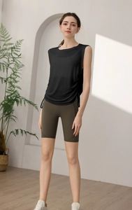 Close-up of black sleeveless sports vest with side drawstring and olive biker shorts with pockets