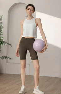 Détail du débardeur de yoga en maille blanche et du short de fitness vert olive
