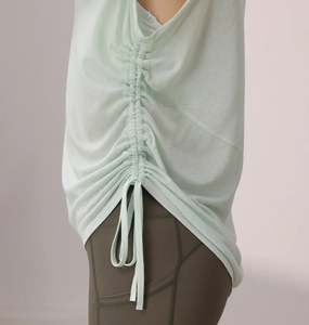 Detail view of the side drawstring ruched texture on this breathable mint yoga tank top