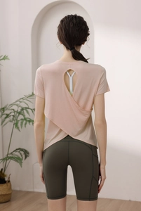 Pink backless yoga top showing crossover cut-out detail and breathable modal fabric