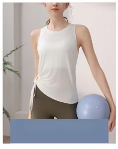 Detail of white mesh yoga tank top with side drawstring ruched design and green leggings