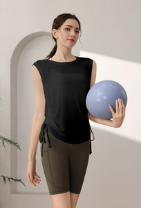 Detail of black drawstring sports vest and olive green yoga shorts with side pockets
