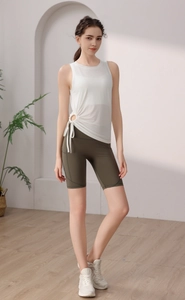 Detail of white sports tank top featuring adjustable side drawstrings and metal rings