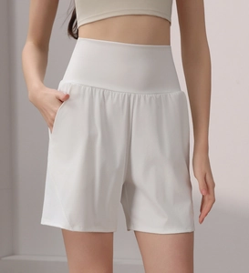 Detail view of high-waist white athletic shorts with wide waistband and side pockets