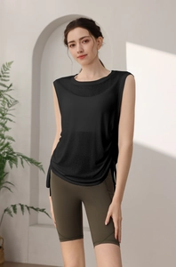 Detail view of the loose-fitting black yoga tank top with side slits on a model
