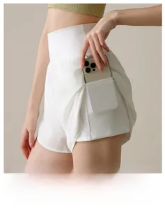 Detail view of white high-waisted sports shorts with built-in phone pocket and mesh fabric