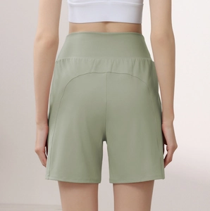 Rear view of high-waisted sage green sports shorts with curved seam for hip shaping