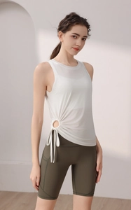 Detail of white drawstring yoga vest with side cinching and sheer breathable fabric