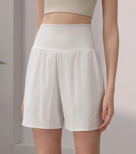 Close-up of white high-waisted fitness shorts with wide waistband for tummy control