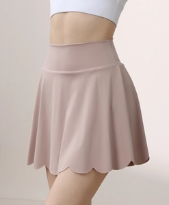 Detail of scalloped hem on high waist yoga skort in dusty pink for tennis and workout