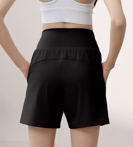High-waisted black yoga shorts featuring curved back seams to enhance the gluteal shape