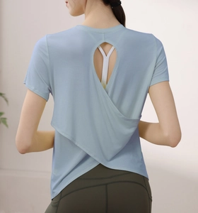 Detail of light blue yoga shirt featuring a water-drop back cutout and criss-cross hem