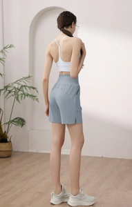 Detail view of women's high-waisted shorts with side slits for fitness and yoga