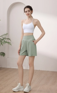 Detail of high waisted mint green shorts and white tank top for yoga and running