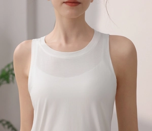 Close-up of white yoga tank top featuring drawstring details and breathable fabric