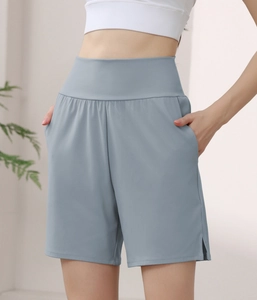 Detail view of high-waisted nylon sports shorts with side pockets and hem side slits