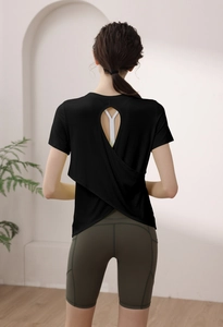 Macro detail of breathable modal back cutout and crisscross hem on women's gym shirt