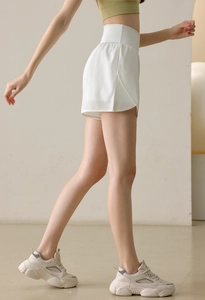 Side view of white high-waisted sports shorts with breathable quick-dry fabric for women