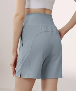 Detail of high-waist athletic shorts featuring side pocket and nylon-spandex fabric