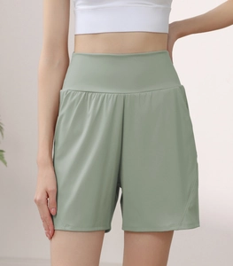 Detail of high waist tummy control athletic shorts with side curved stitching in bean green