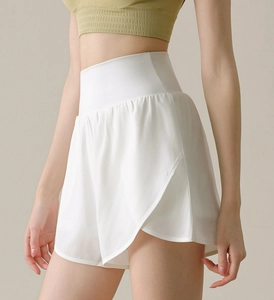 Close-up of high-waisted white sports shorts with wide waistband and curved hem design