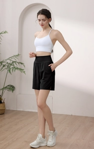 Detail view of high waist loose running shorts with side pockets and sports bra set