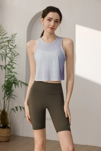 Détail du débardeur de sport mauve respirant et du short de cyclisme vert olive