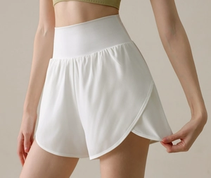 Macro detail of white high-waisted sports shorts with double-layer design and side slits